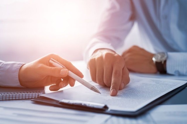 businessmen reviewing contract