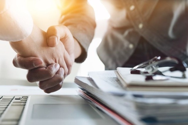 businessmen shaking hands over deal