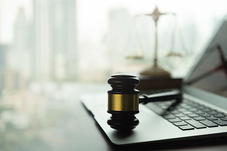 Laptop with gavel in city window