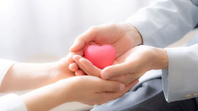 People holding heart symbol