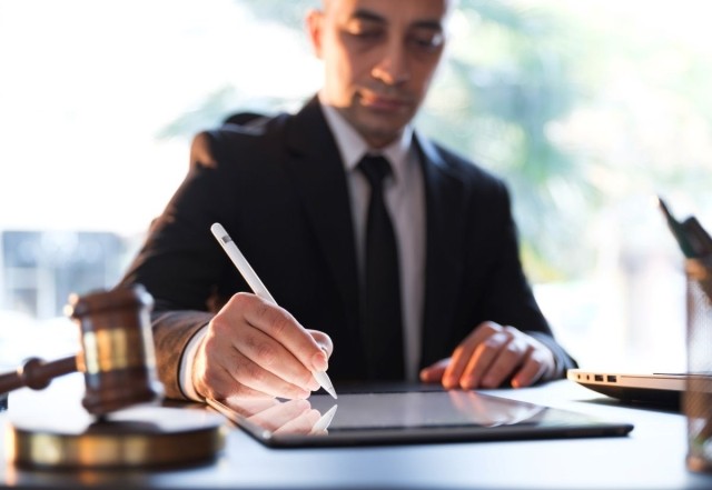 Businessman in formal attire using a tablet