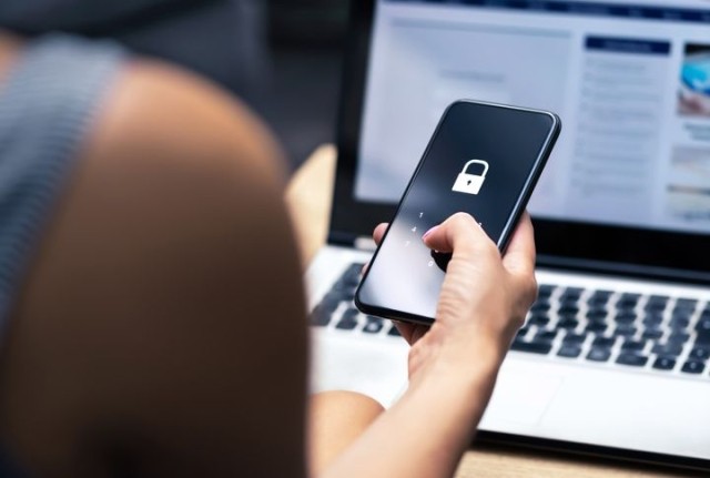 Woman putting in password on phone to unlock