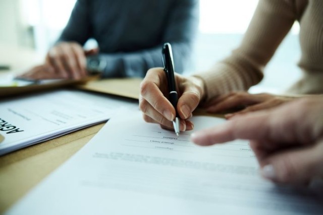 two people signing contract