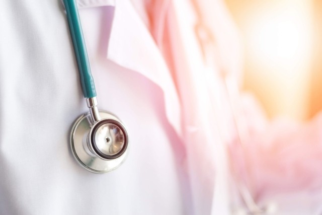 Doctor wearing white coat and stethoscope during consultation