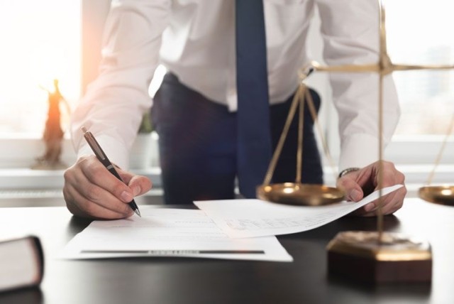 Lawyer writing contract justice scale