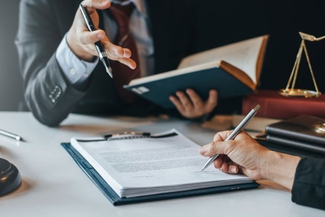 Lawyer signing contract books