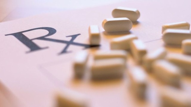 Doctor's prescription notepad and medication pills