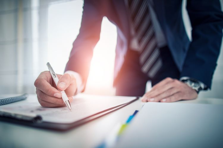 Businessman signing document
