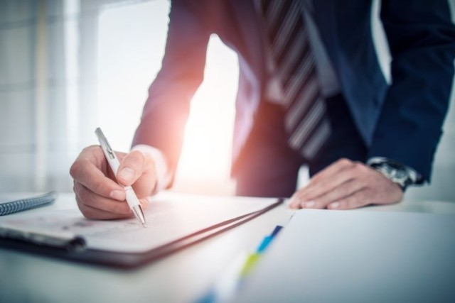 Businessman signing document