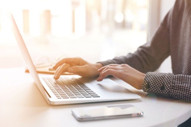 woman typing on laptop